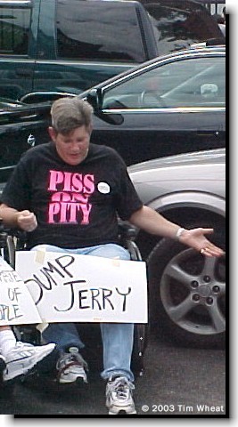 PHOTO: MCIL advocate with a Piss on Pity t-shirt and a Dump Jerry sign