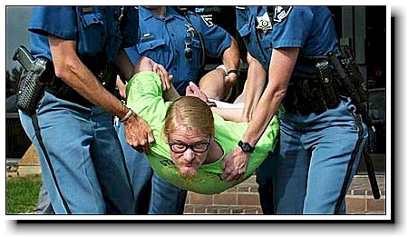 Tim Wheat being arrested at the office of Senator Wayne Allard.