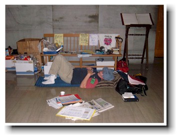 A protestor sleeps on the floor, near the supply of food in the Capitol.