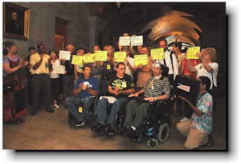 About 20 activists speak with the press.