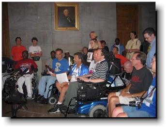 about 20 sit-in activists hold a press conference in the capitol.