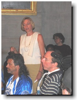 Carol Westlake stands with protestors.