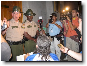 Activists are blocked by state police from the governor's office.